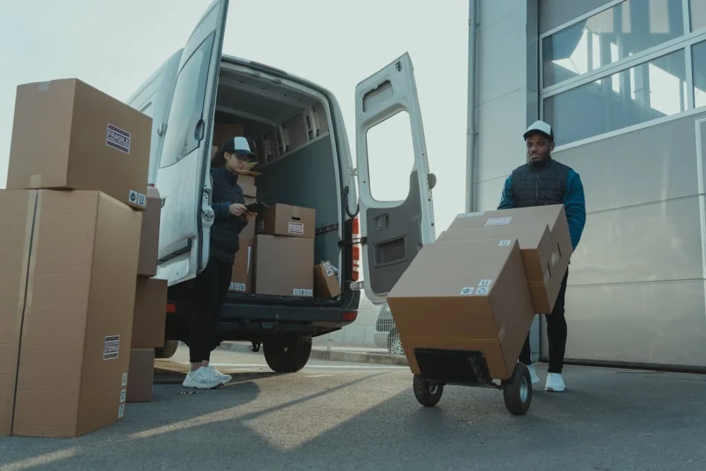 people moving boxes from a van